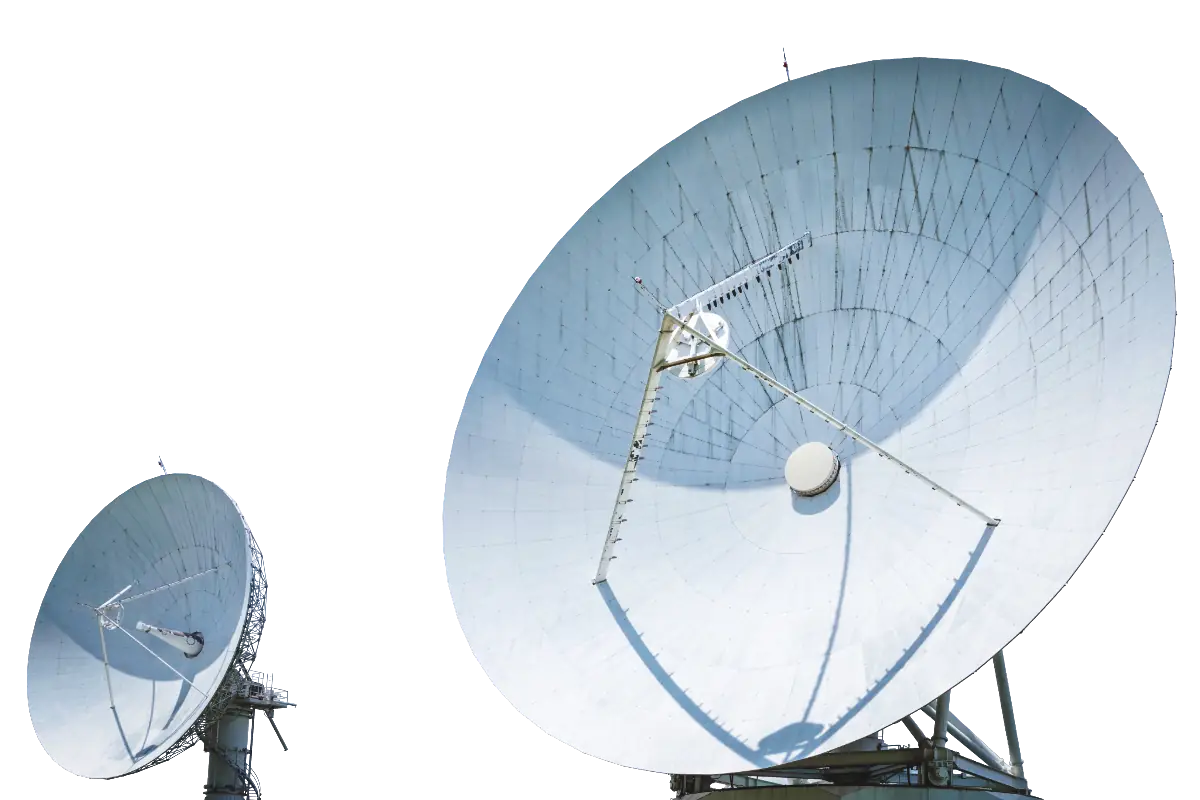 Two large satellite ground-station dishes angled at the sky, the uplink equipment whose bandwidth constraints rule out a rip-and-replace upgrade.